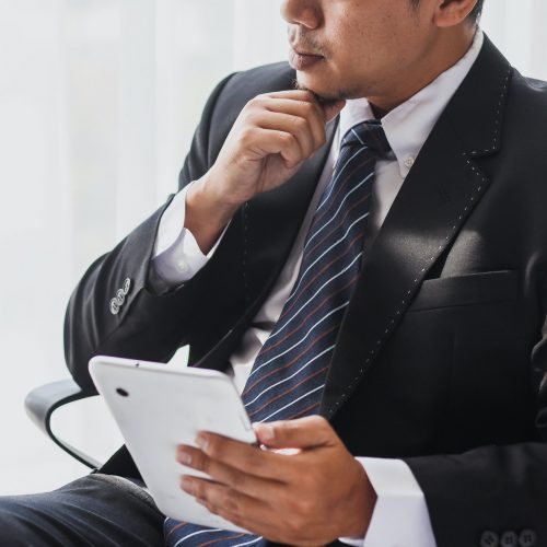 Businessman thinking on a chair Businessman thinking on a chair